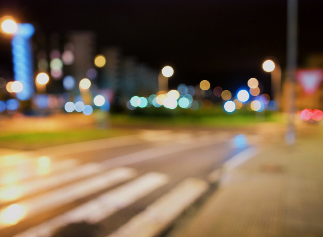 A night street where every light has become a large soft circle of colour