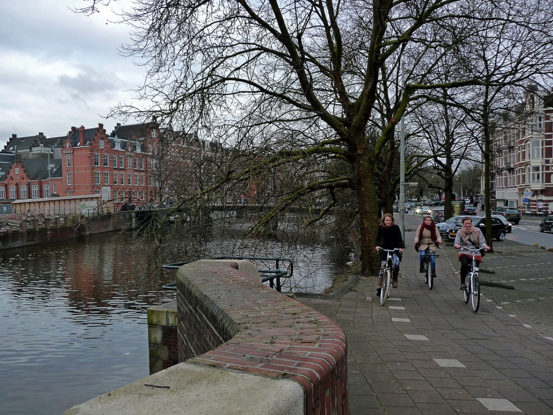 A city street scene sharp from the wall in the foreground to the buildings far away