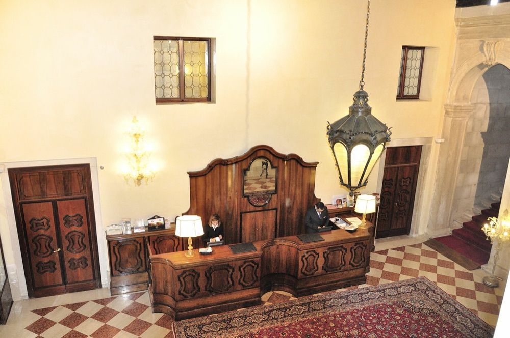 A dim, warmly lit hotel lobby interior
